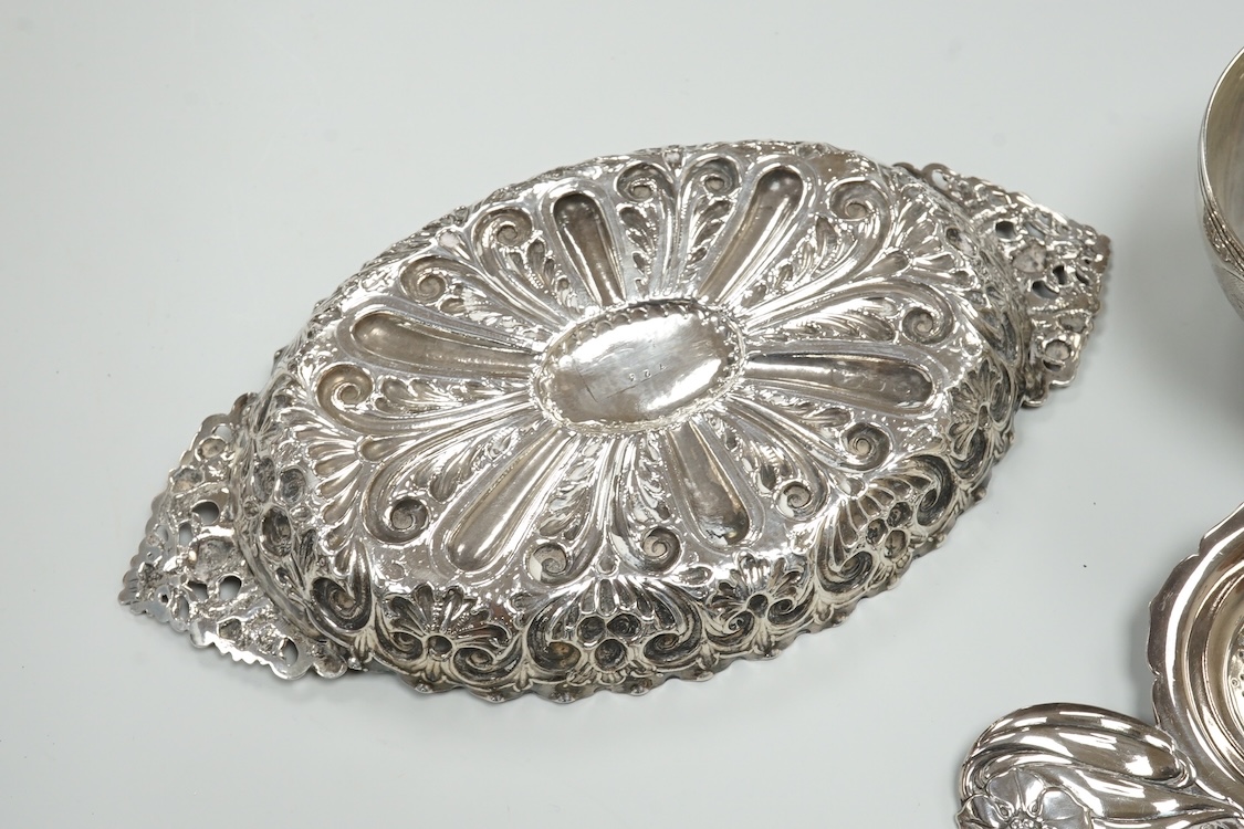 A late Victorian repousse silver navette shaped dish, by Charles Edwards, London, 1894, 25.7cm, with engraved monogram and date, together with a pair of mid 18th century silver sugar nips, an early 19th century silver vi